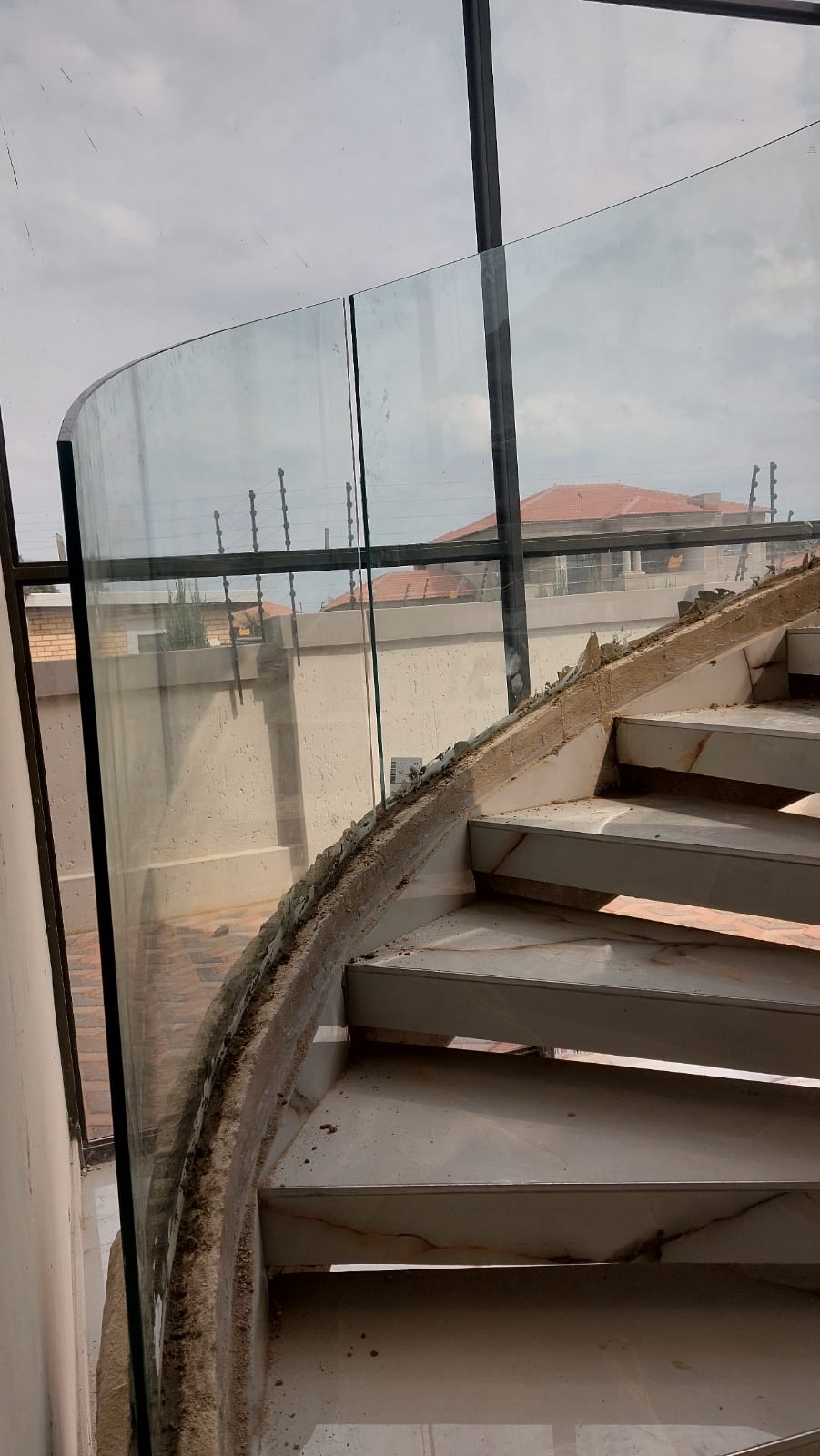 Custom curved glass staircase engineered to site